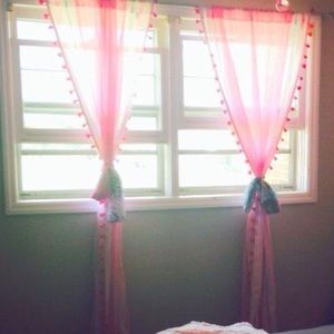 Tasseled sheer pink and white curtain panels